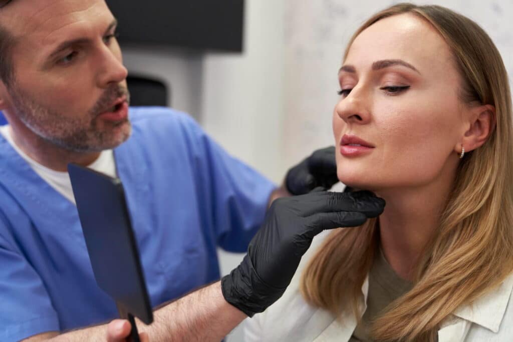 cosmetologist discussing sculptra vs radiesse treatment