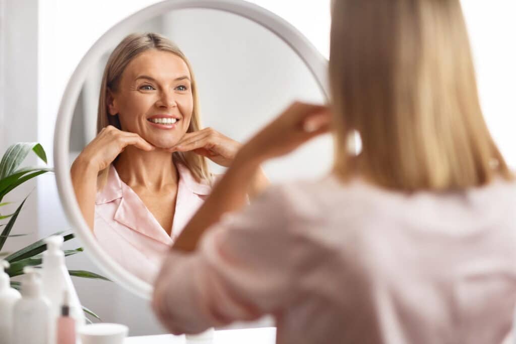 woman happily looking at her reflection