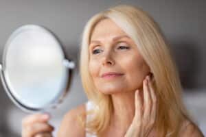 elderly woman looking in the mirror